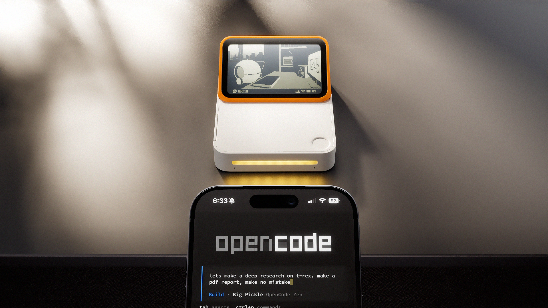 A Lapis One behind an iPhone showing an AI agent task in progress.
