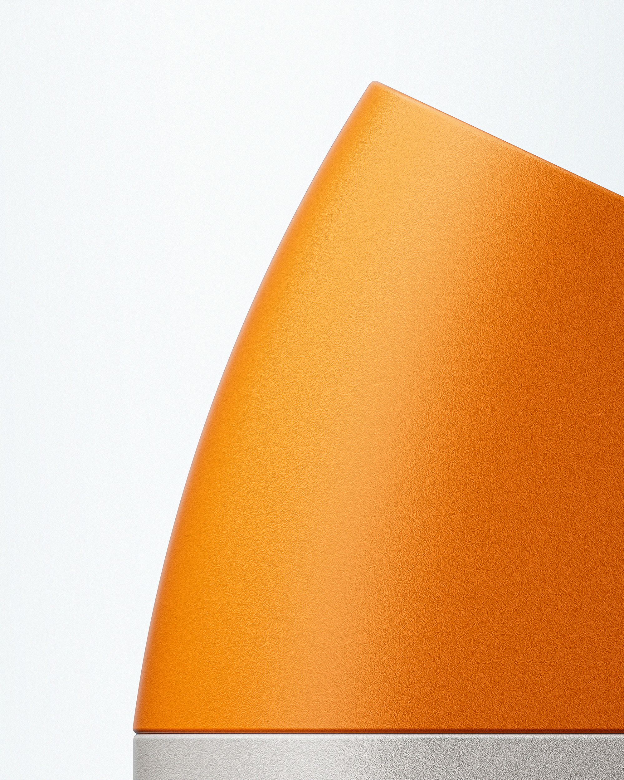 An orange object with a subtle curve on its left, sitting atop a white base.